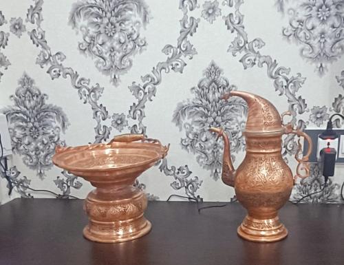 a vase and a vase on a table at Keviz Homestay in Jawāharnagar
