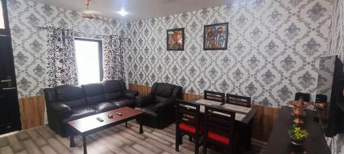 a living room with a couch and a table at Keviz Homestay in Jawāharnagar