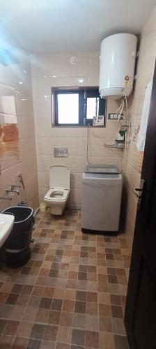 a small bathroom with a toilet and a sink at Keviz Homestay in Jawāharnagar