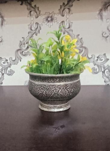 a vase with flowers in it sitting on a table at Keviz Homestay in Jawāharnagar