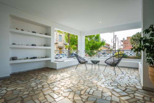 a room with two chairs and a large window at Magical Seaside Town Boutique Apts 2 in Kyparissia