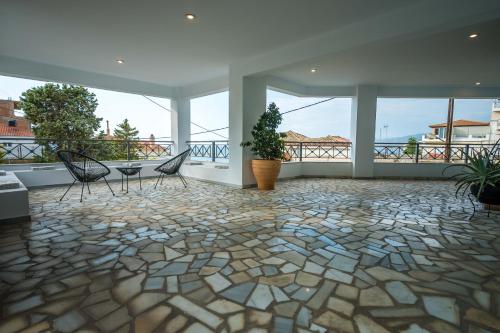 a room with two chairs and a table on a balcony at Magical Seaside Town Boutique Apts 2 in Kyparissia