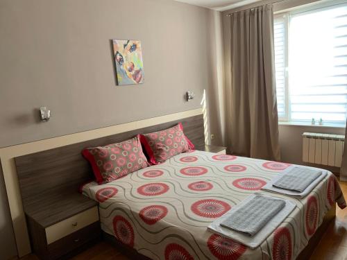 a bedroom with a bed with a keyboard on it at Asinela Home с гараж in Burgas City