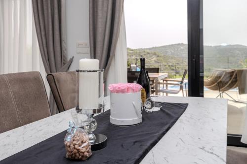 a table with a candle and flowers on a table at View Villas Collection in Vinišće