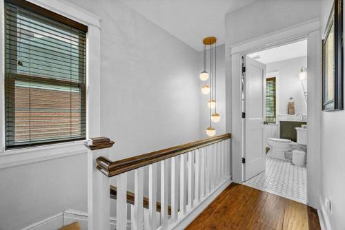 a hallway with a staircase with a toilet and a window at Fantastic Family Home in Central Mount Washington in Pittsburgh