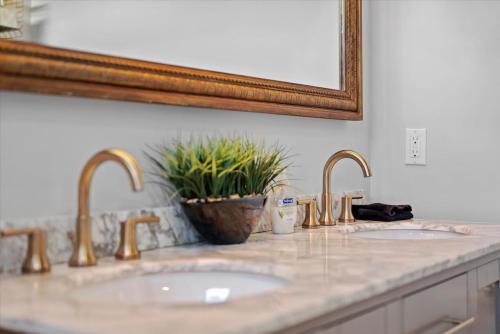 a bathroom counter with two sinks and a mirror at Fantastic Family Home in Central Mount Washington in Pittsburgh