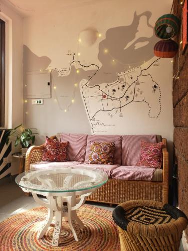 a living room with a couch and a table at Laxmi Happy Home in Querim Goa in Querim