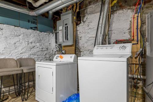 two washing machines in a room with a wall at Fantastic Family Home in Central Mount Washington in Pittsburgh