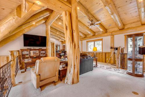 a living room with wooden ceilings and a vaulted ceiling at Scenic Payson Cabin with Wraparound Patio in Payson