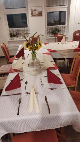 a table with red and white napkins and utensils on at Zur Schlinge in Siebenhitz