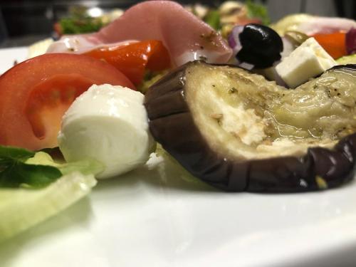 a plate of food with vegetables and other foods at Fachwerk-Hotel Eisenbart in Hannoversch Münden