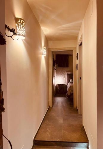 a hallway with a room with a bed and a light at La casa di Teo Pescocostanzo in Pescocostanzo