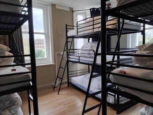 a room with a bunch of bunk beds at Bell House Hostel in London