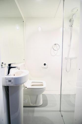 a bathroom with a toilet and a sink and a shower at NE1 City Studios & Apartments in Newcastle upon Tyne