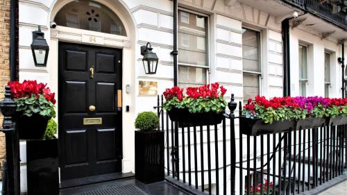 a black door and flowers on a house at The Sumner Hotel in London