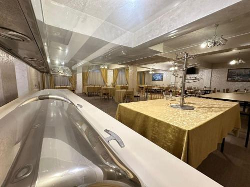 a bath tub in a room with a table and chairs at Family Hotel - Free Massage in Baku