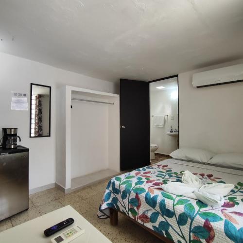 a hotel room with a bed and a table at Margaritas in Cancún