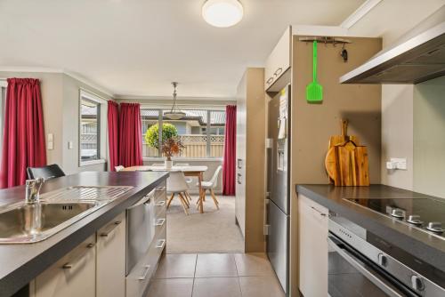 a kitchen with a counter and a dining room at Beauty on Bantry - Alexandra Holiday Home in Alexandra