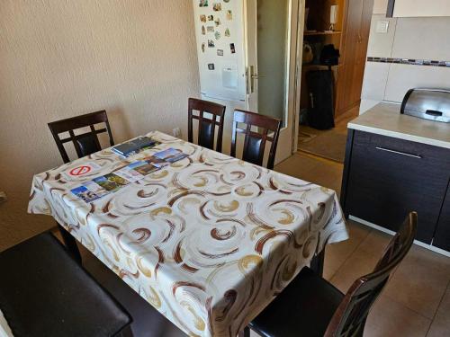 a table with a table cloth on it in a kitchen at Apartman Veki in Subotica