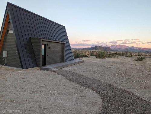 a building with a door on the side of it at Stardust Big Bend Luxury A-Frame#5 great views in Terlingua