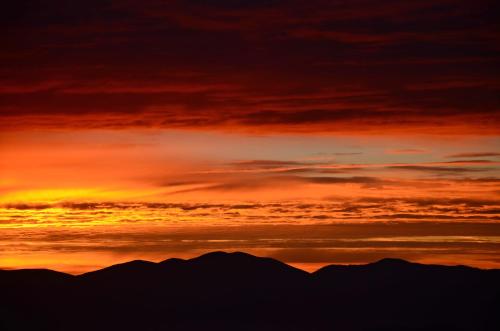 a sunset with mountains in the background at Pension Sandhof in Knittelfeld