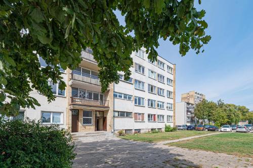 an apartment building with a sidewalk in front of it at Pramonės Apartment #5 by PoloApartments in Kaunas