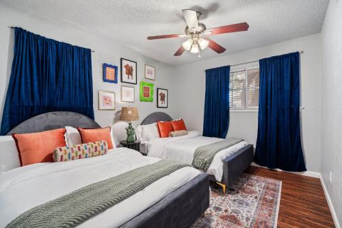 a bedroom with two beds and a ceiling fan at 4bd Near Airport & Downtown - Volleyball - Games in Irving