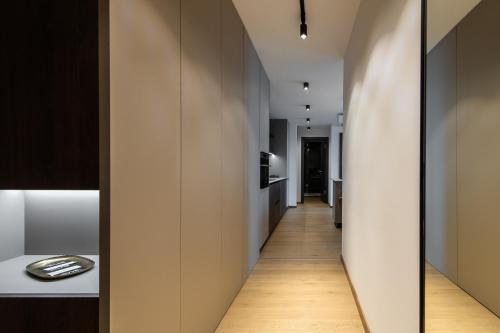 a hallway leading to the kitchen of a apartment at Nikas Eurovea Apartments - free parking in Bratislava