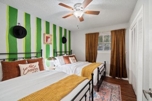 two beds in a room with green and white stripes at 4bd Near Airport & Downtown - Volleyball - Games in Irving