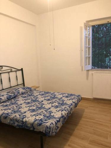 a bedroom with a bed in a room with a window at La vecchia quercia in Carini