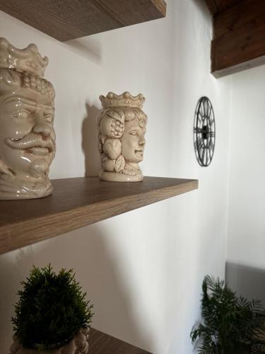 two vases sitting on a shelf in a room at Moro House in Sferracavallo