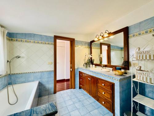 a bathroom with a tub and a sink and a bath tub at YourHome - Casa Carmela in Colli di Fontanelle