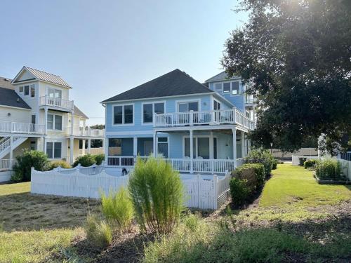 a large blue house with a white fence at CCHK70 Peace of Paradise in Corolla