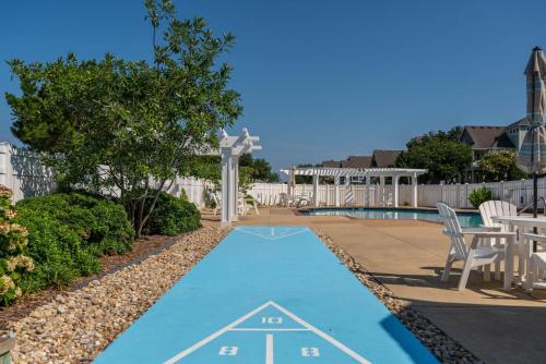 a blue painted path next to a swimming pool at CCHK70 Peace of Paradise in Corolla