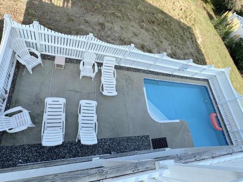 a patio with chairs and a swimming pool at CCHK70 Peace of Paradise in Corolla