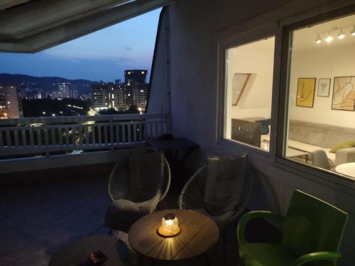 a balcony with a table and chairs and a window at Apartment 075 in Tuzla