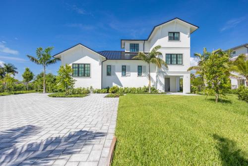 a large white house with a large yard at Brand New Catchlight House with Private Pool in Key West
