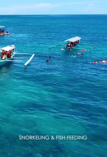 two boats in the water with people on them at Villa Tobias San Juan Batangas in Batangas City