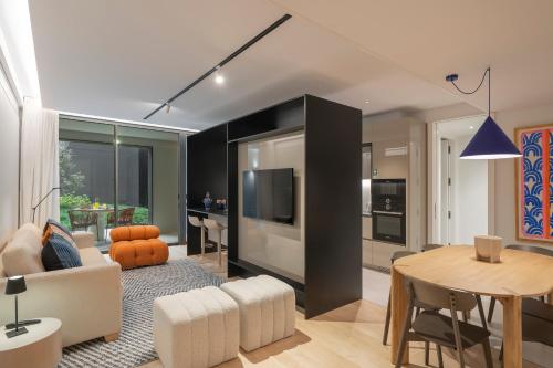 a living room with a kitchen and a dining room at Luxury Garden Apartment at Savoy Insular in Funchal