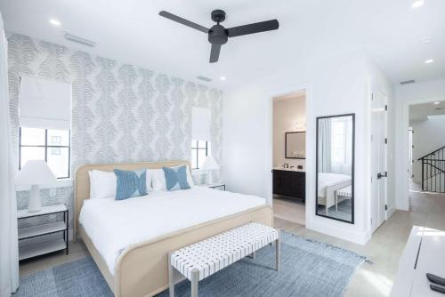 a bedroom with a bed and a ceiling fan at Brand New Catchlight House with Private Pool in Key West