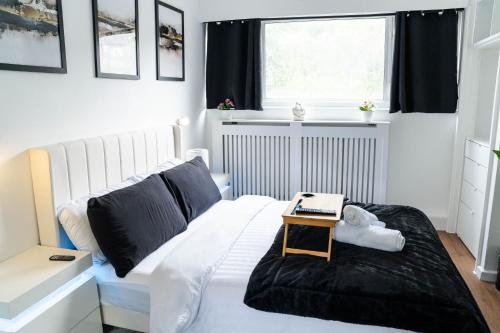 a bedroom with a bed with a table on it at Modern 1 bed apartment in Greenwich - WIFI - NETFLIX and stations nearby in London