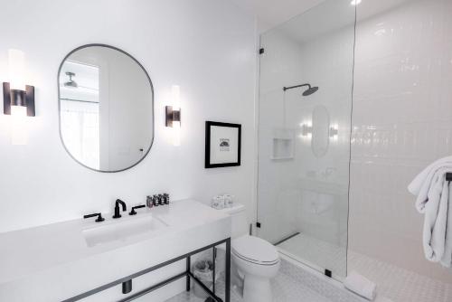 a white bathroom with a toilet and a shower at Brand New Catchlight House with Private Pool in Key West