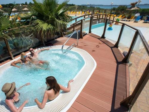 a group of people in a swimming pool at a resort at La cabane des rêves in Pérols