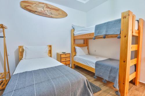 a bedroom with two bunk beds and a bed at Moon Surf in Imsouane