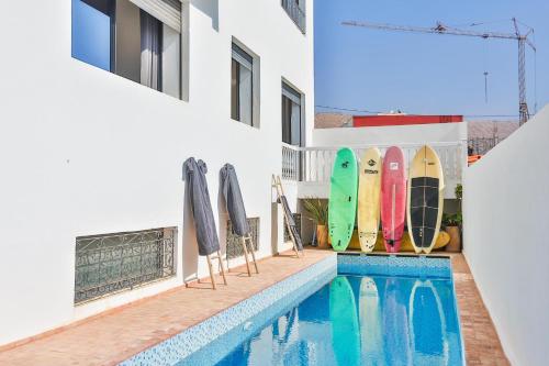 a pool with surfboards on the side of a building at Moon Surf in Imsouane
