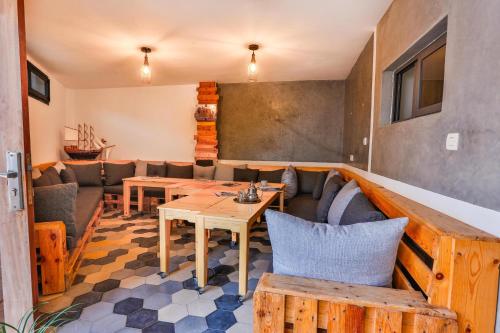 a living room with a table and a couch at Moon Surf in Imsouane