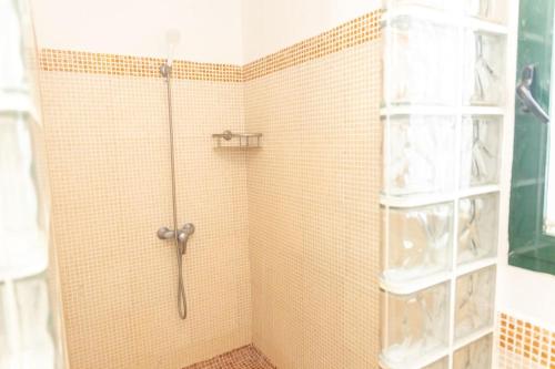 a shower with a glass door in a bathroom at Chalet Adosado Susurros Marinos in Zahara de los Atunes