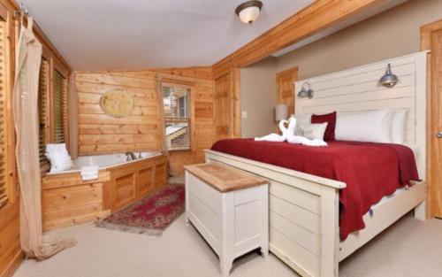 a bedroom with a bed and a bath tub at Simones Cottage in Gatlinburg