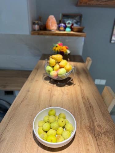 a bowl of lemons and a bowl of fruit on a table at Istisu Valley Spa in İsmayıllı