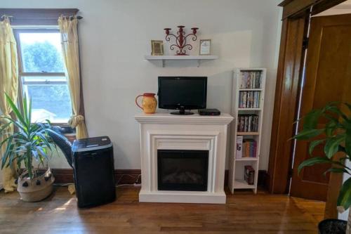 a living room with a fireplace with a tv on it at Gîte Richmond Inn in Richmond